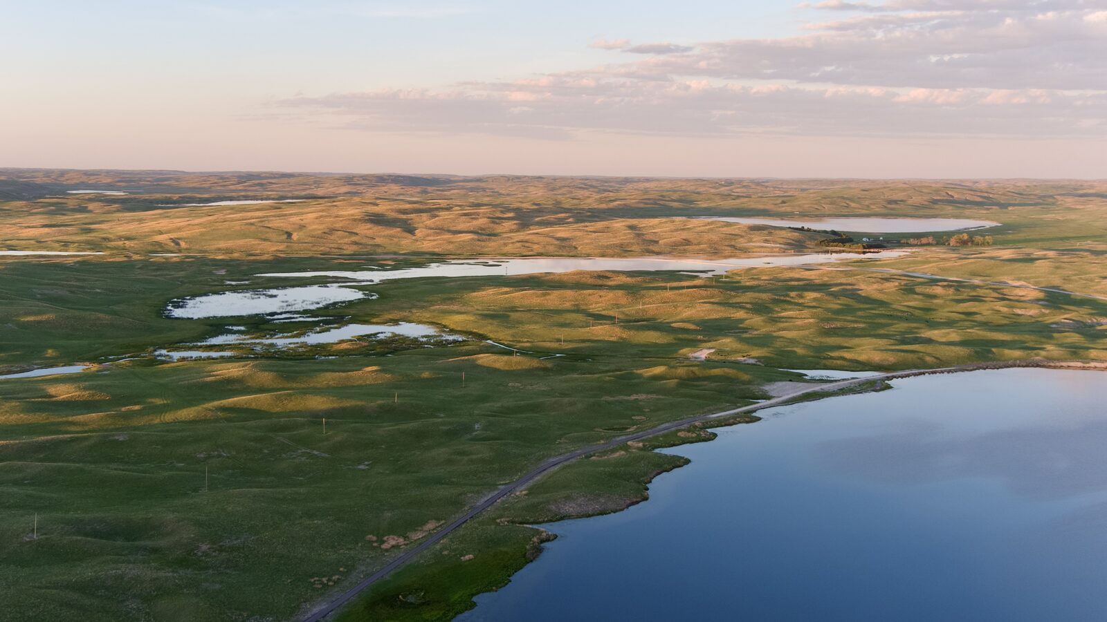 Drone view of Lake Alkali showing interconnected lakes, ponds, and streams at The Main Place